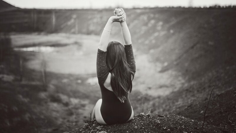 woman stretching on a hill