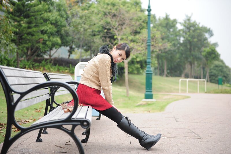 Woman stretching on a park bench