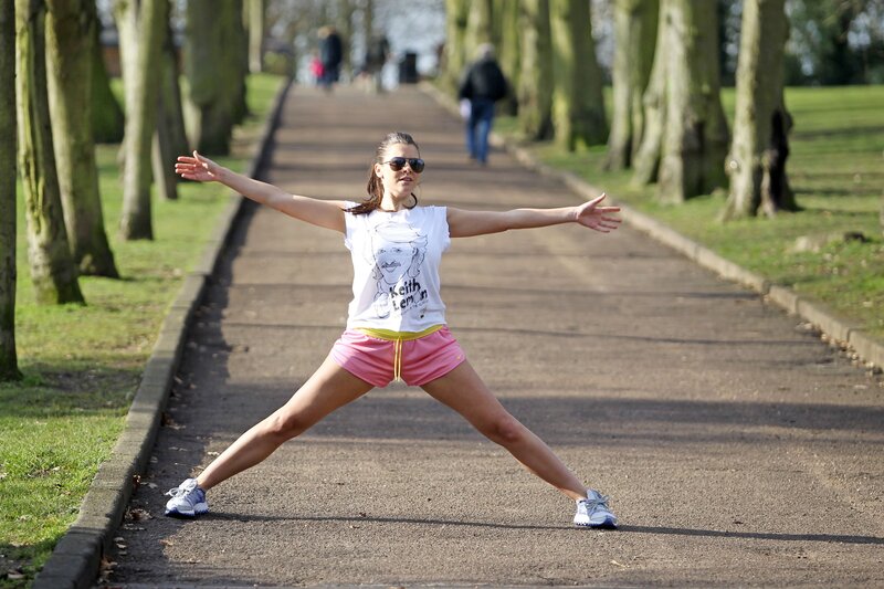 Woman stretching on a park path