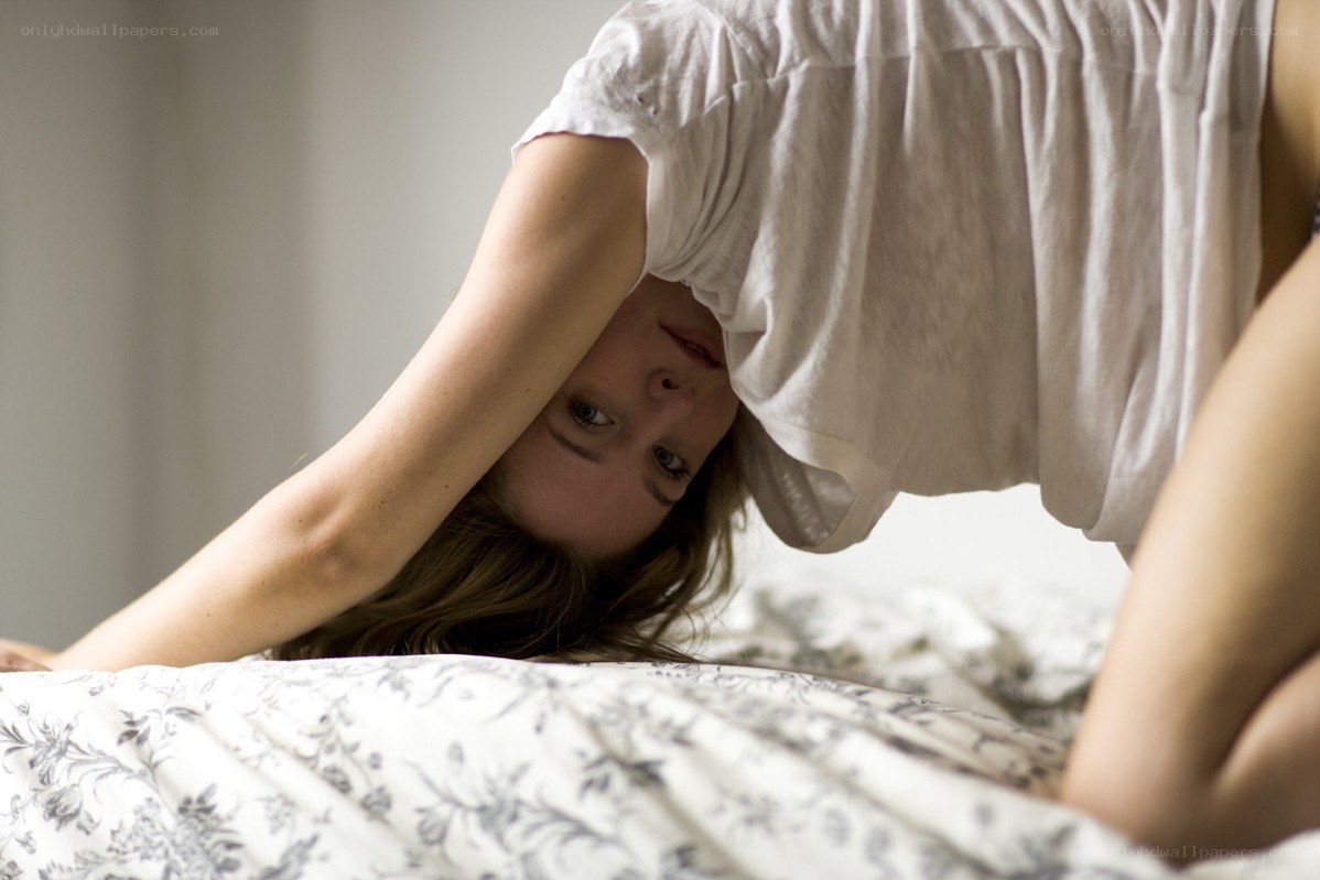 woman stretching on bed