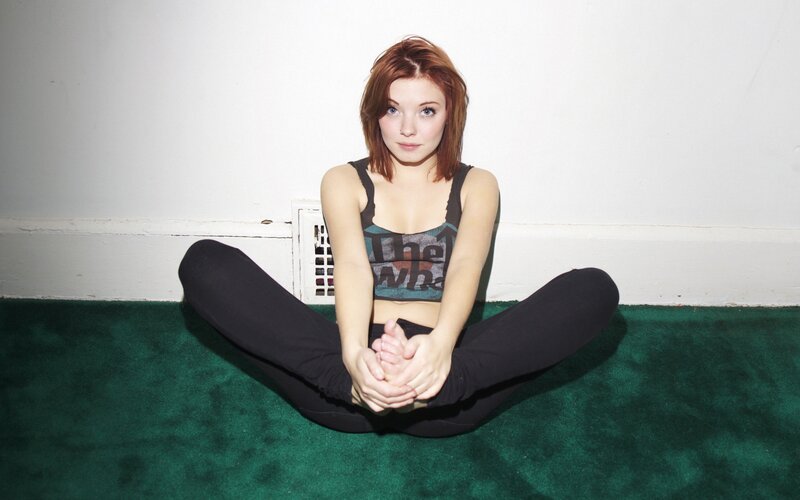 woman stretching on green carpet
