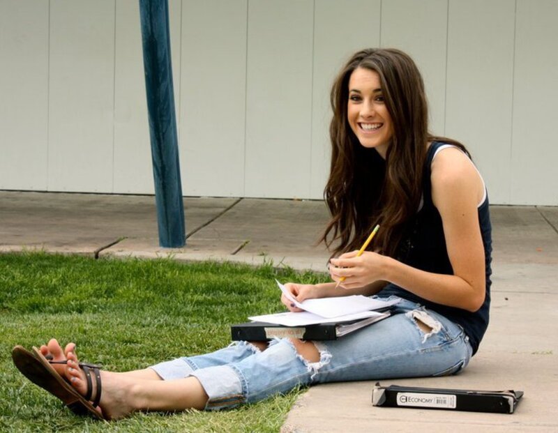 Woman Studying on Grass