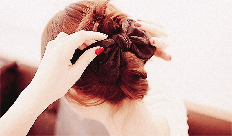 woman styling her hair