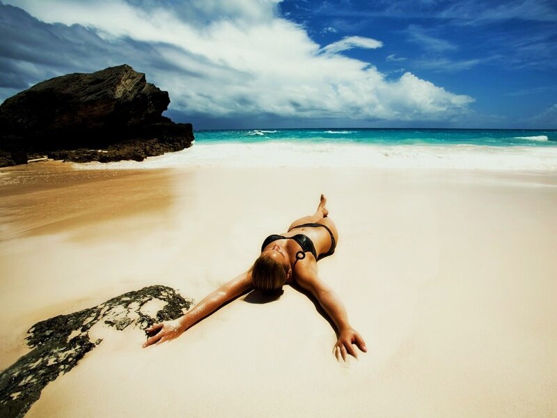 Woman sunbathing on beach