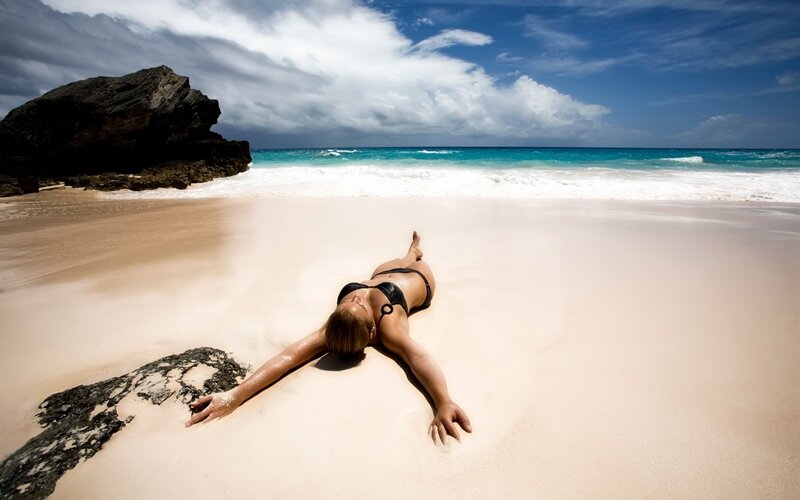 Woman sunbathing on beach
