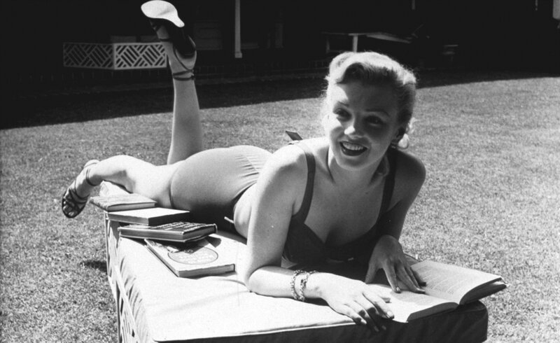 Woman sunbathing on lounge chair