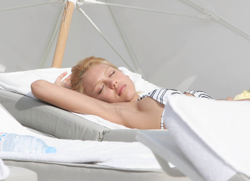 Woman sunbathing on lounge chair