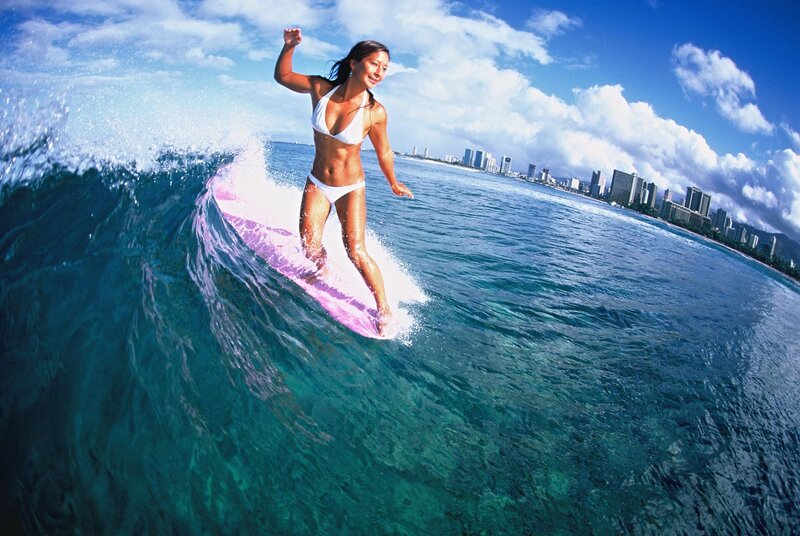 Woman surfing in ocean