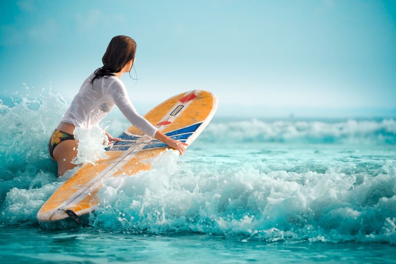Woman Surfing in Ocean — Blue