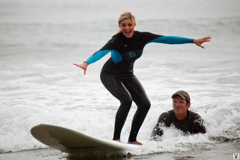 woman surfing in wetsuit