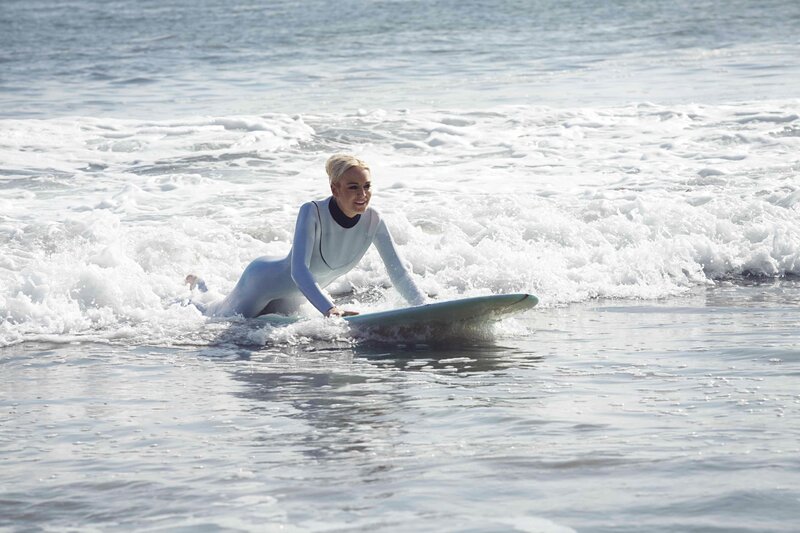 woman surfing in wetsuit