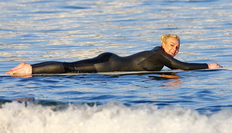 woman surfing in wetsuit