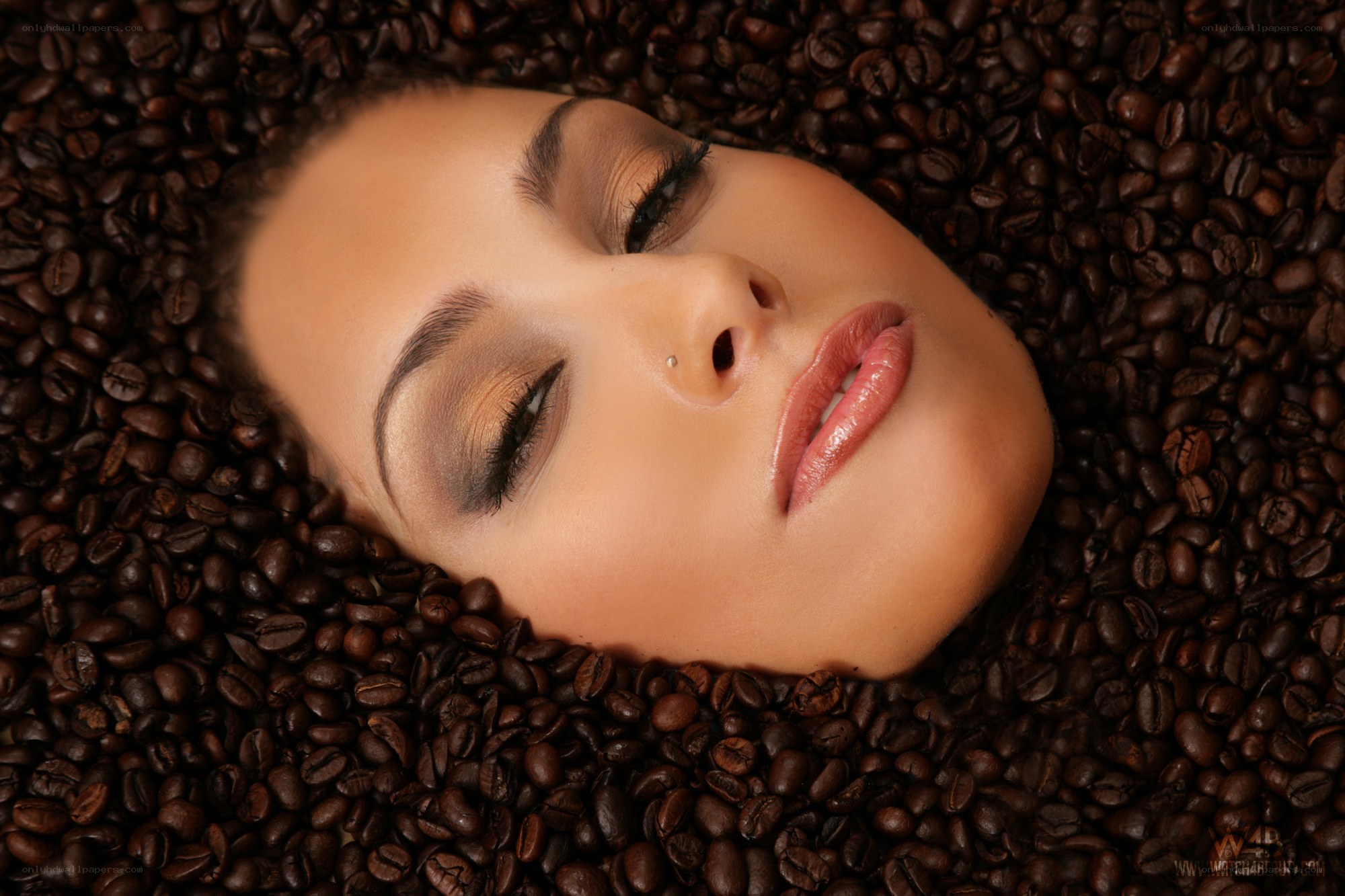 woman surrounded by coffee beans