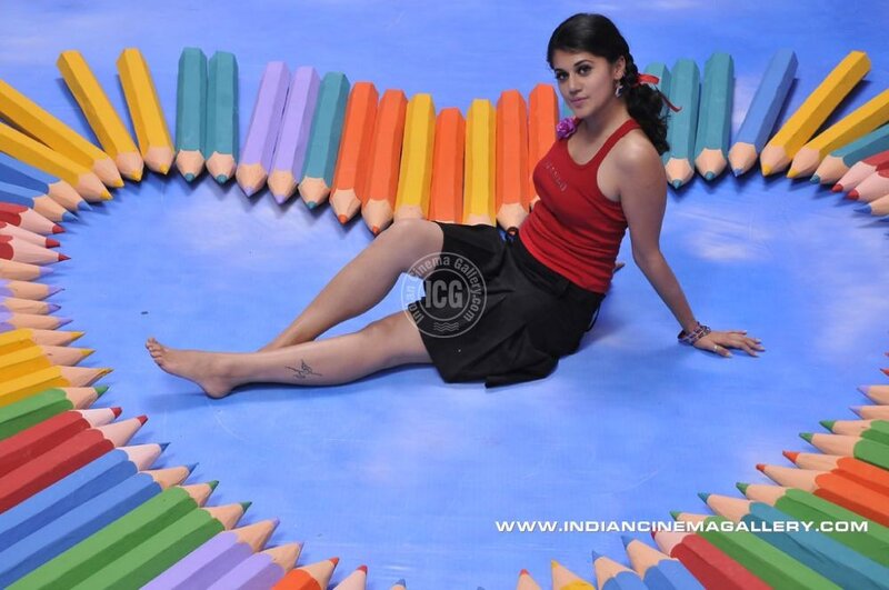 woman surrounded by colored pencils