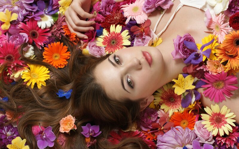 woman surrounded by colorful flowers