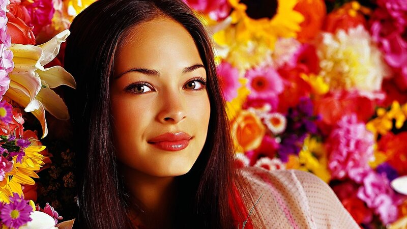 woman surrounded by colorful flowers