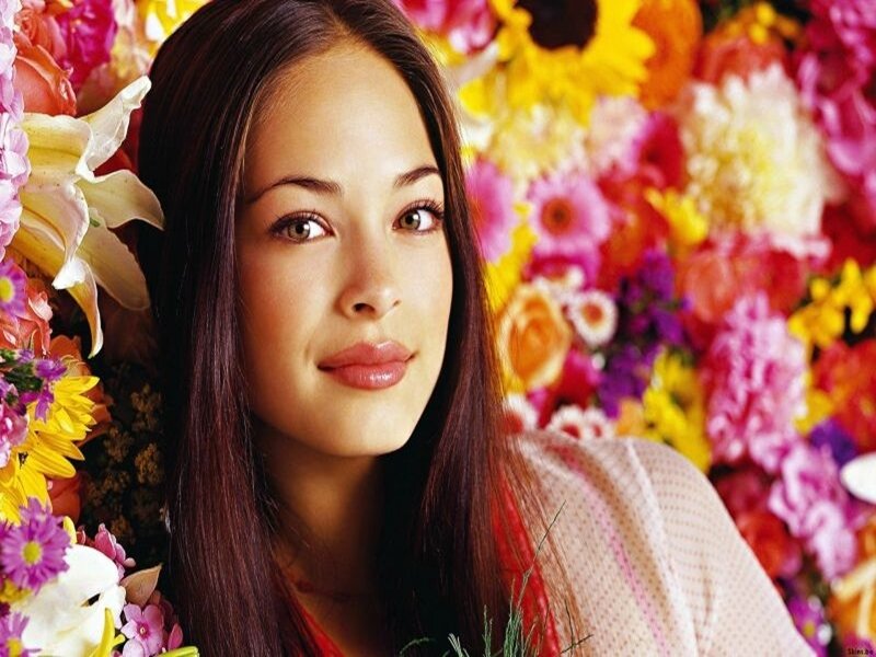 woman surrounded by colorful flowers