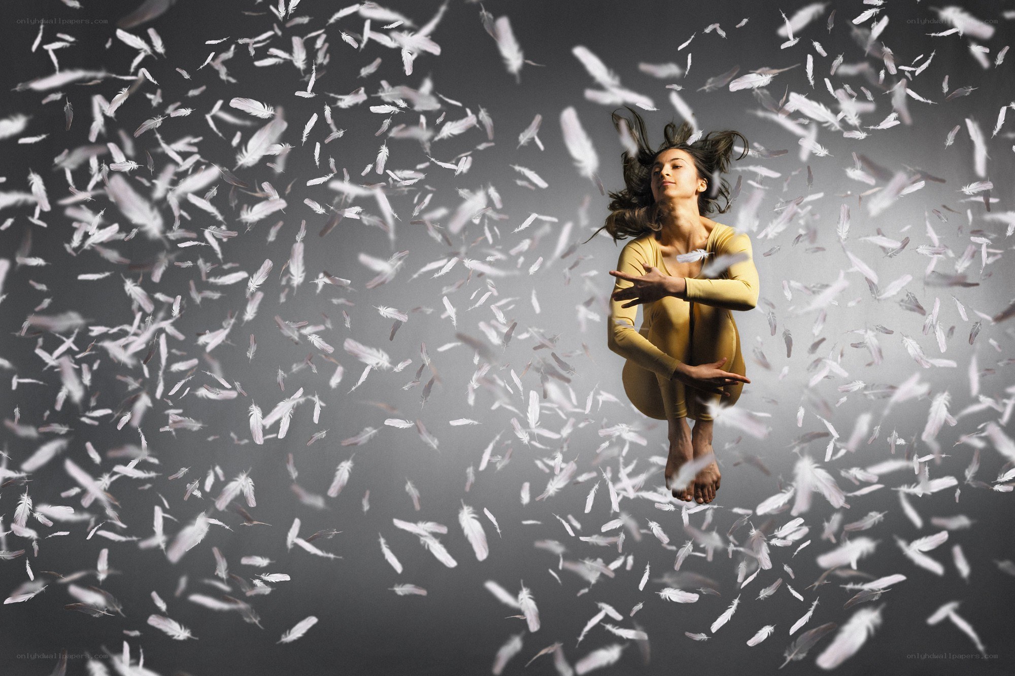 woman surrounded by falling feathers