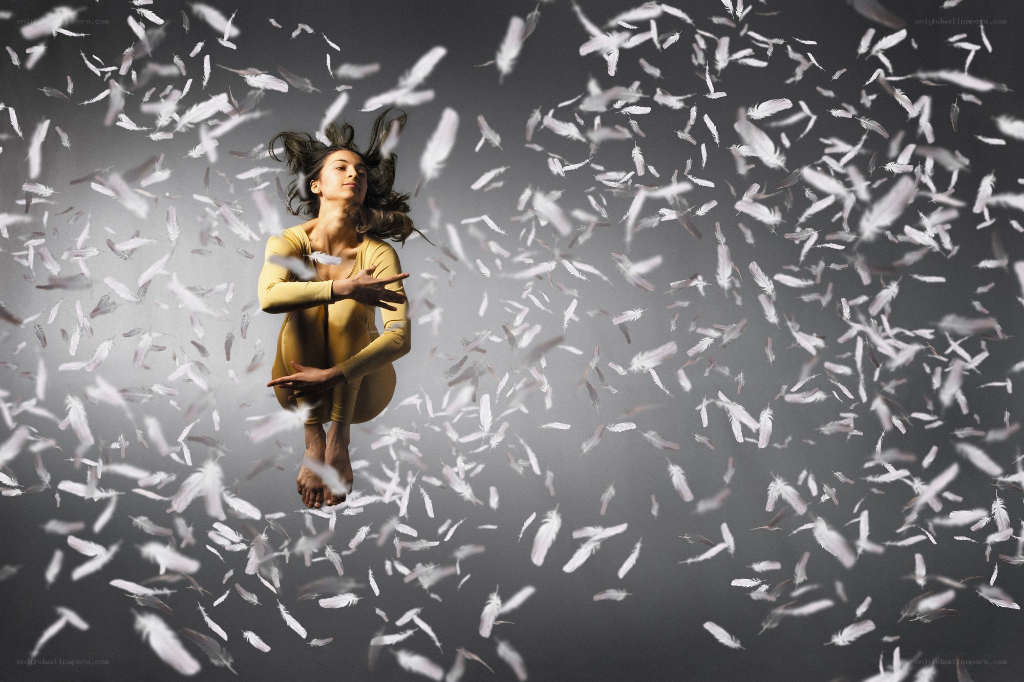 woman surrounded by feathers