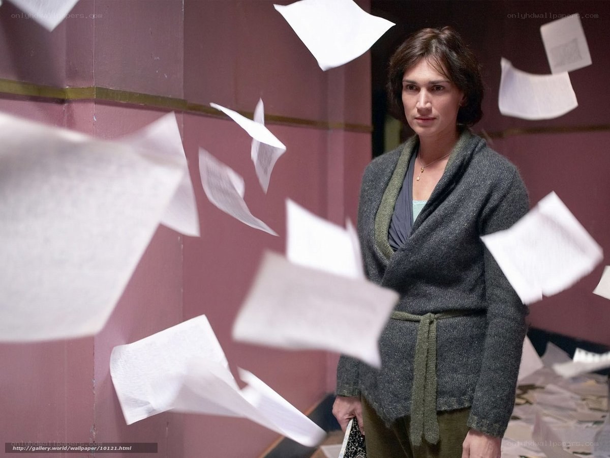 woman surrounded by flying papers