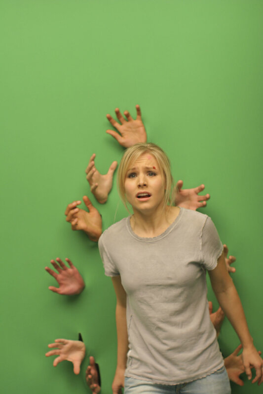 woman surrounded by hands on green screen