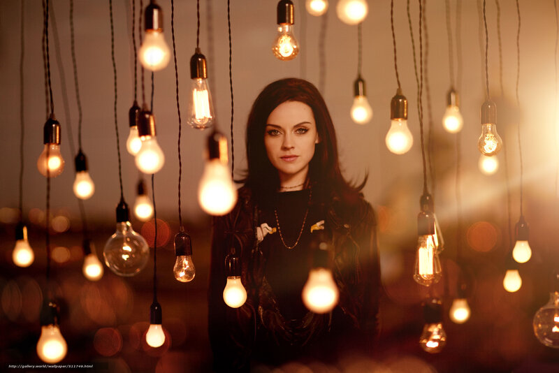 woman surrounded by hanging light bulbs