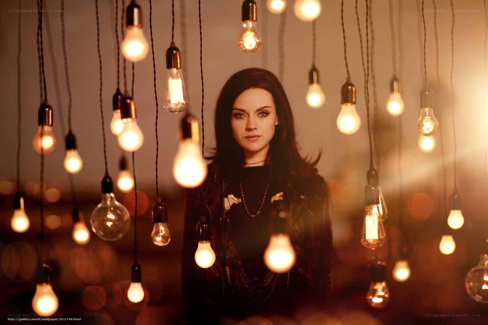 woman surrounded by hanging light bulbs