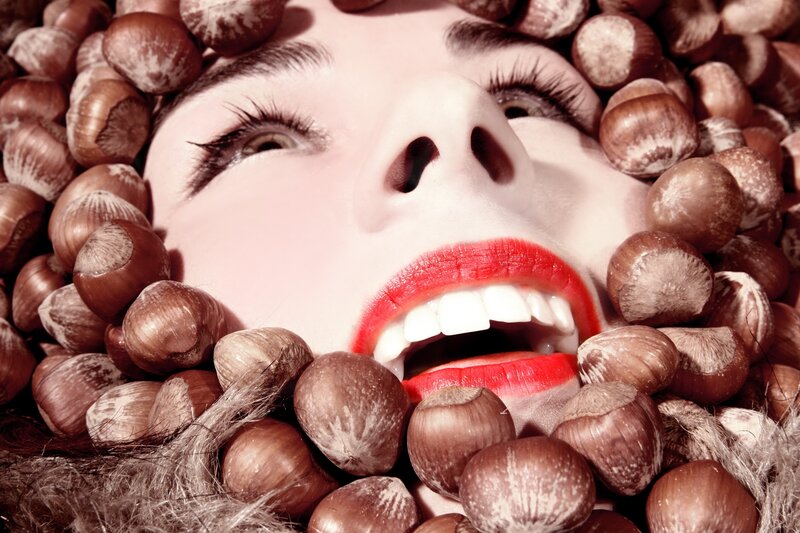 woman surrounded by hazelnuts
