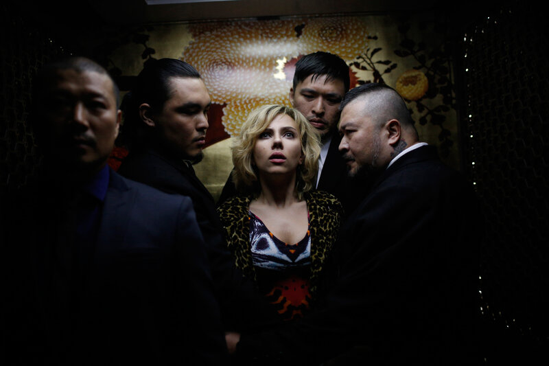 Woman surrounded by men in elevator
