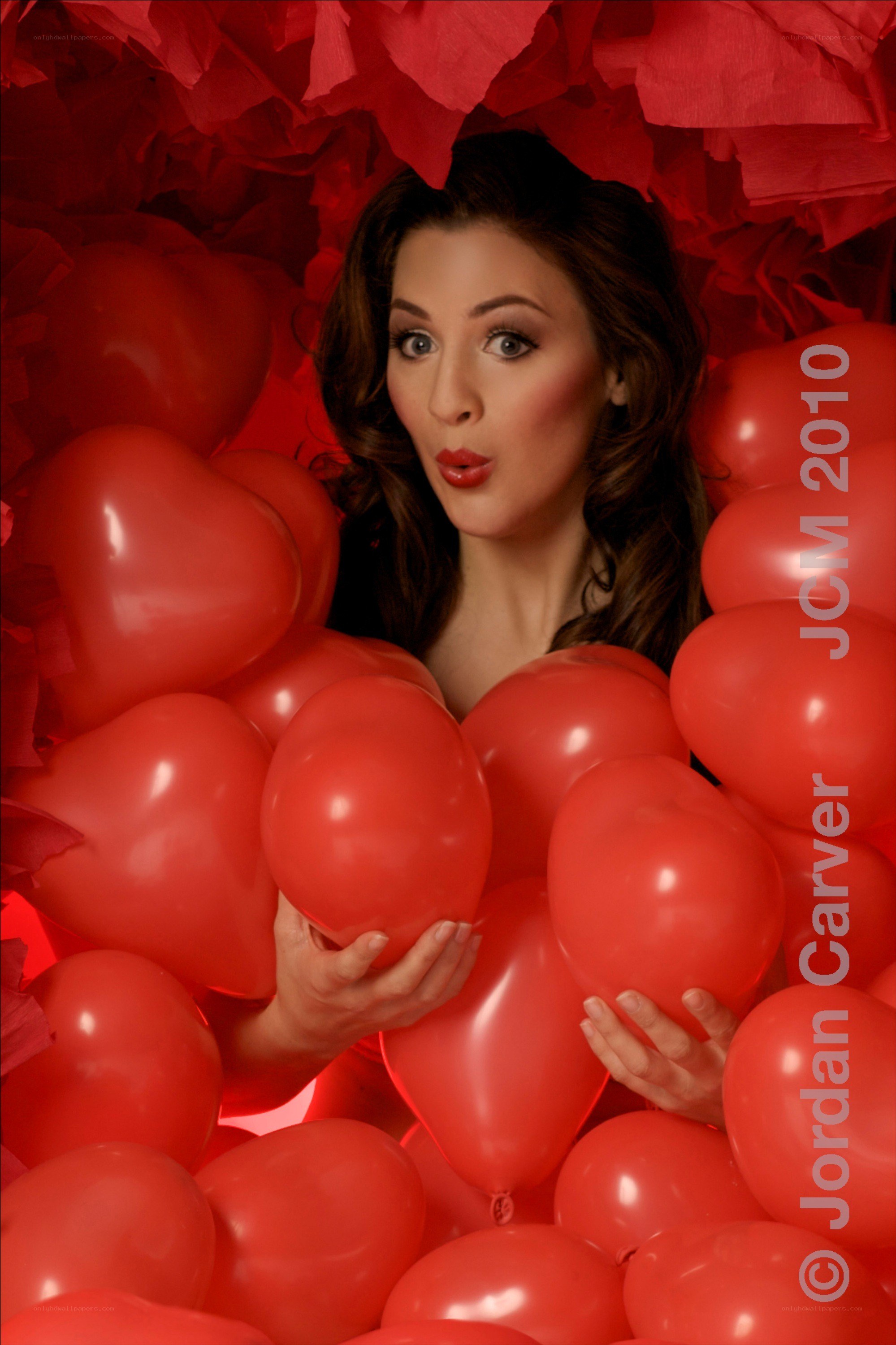 woman surrounded by red balloons