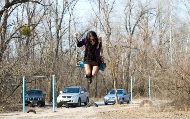 Woman swinging on a tire swing