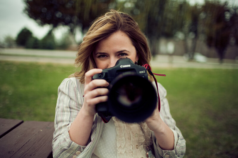 woman taking a photo outdoors