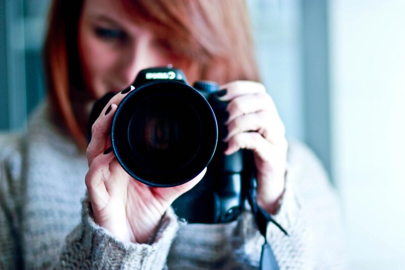 woman taking a photo with camera