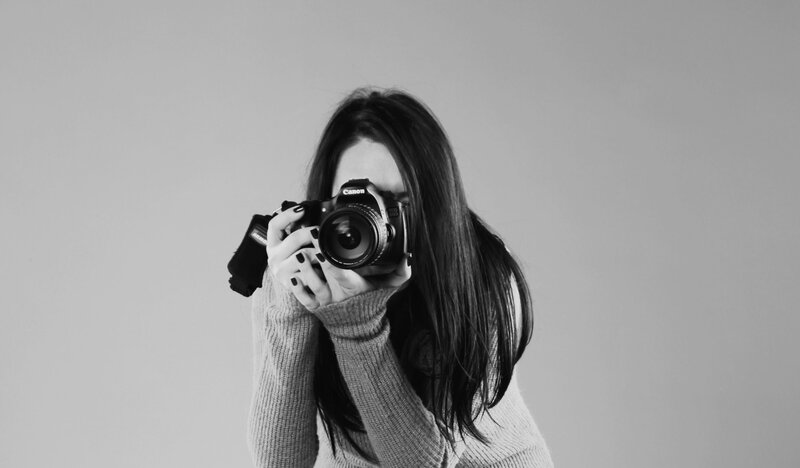 woman taking a photo with camera