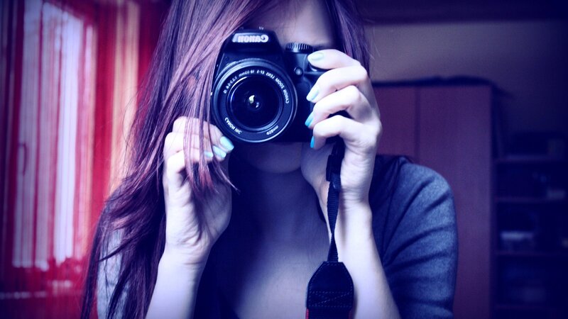woman taking a photo with camera