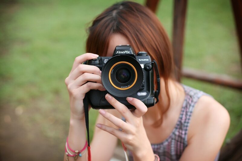 woman taking a photo with camera