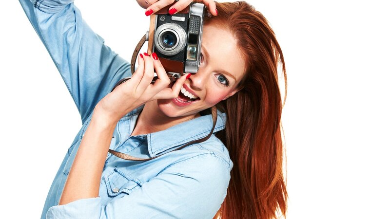 woman taking a photo with vintage camera