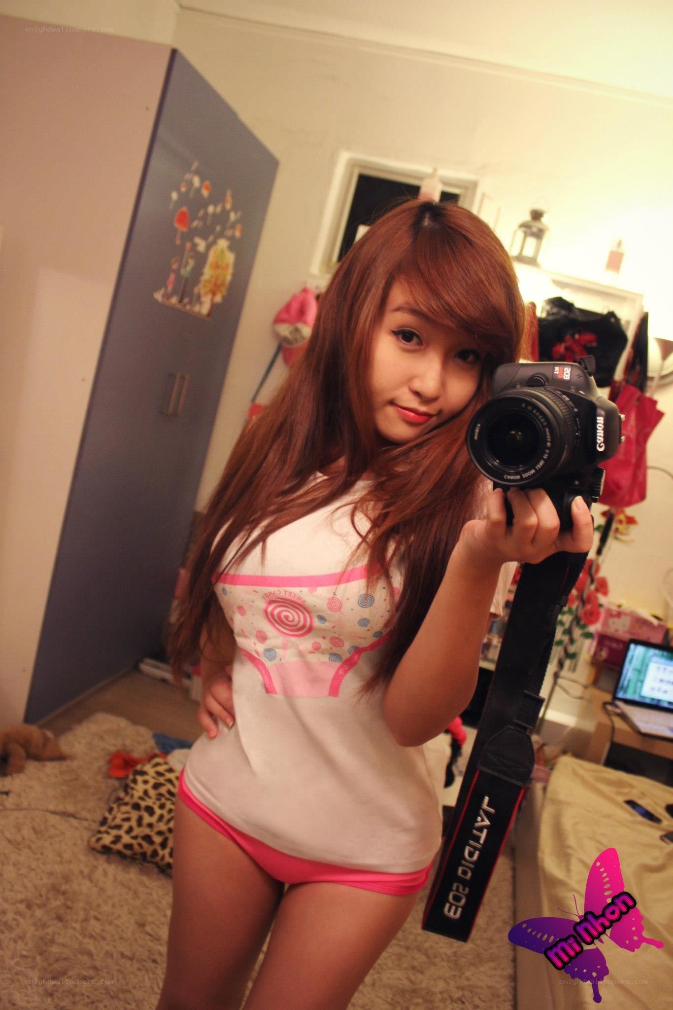 woman taking mirror selfie with camera