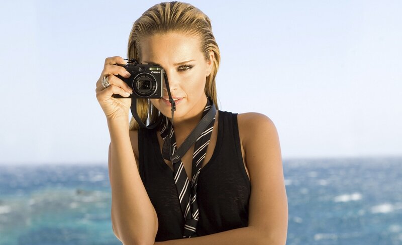 woman taking photo at beach