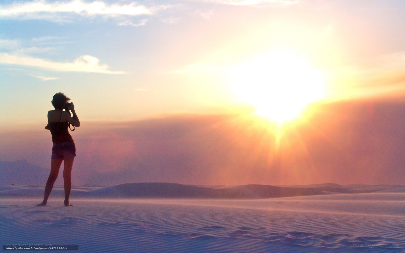 woman taking photo at sunset