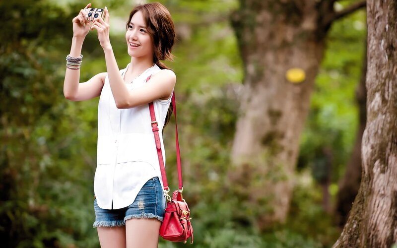 woman taking photo in park