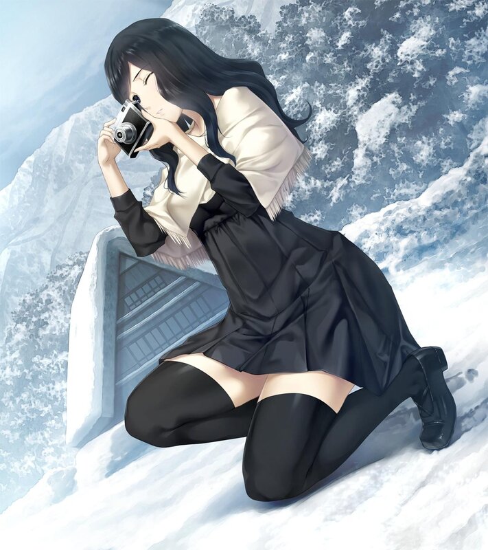 Woman taking photo in snow
