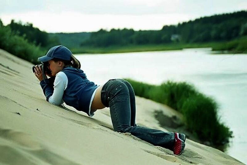 Woman Taking Photo on Sand