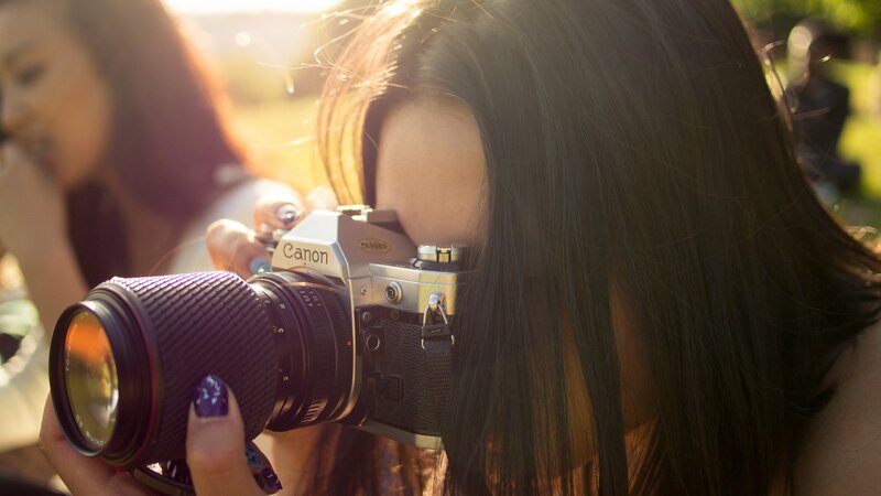woman taking photo with camera