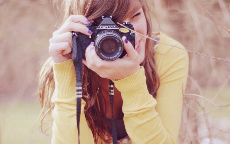 woman taking photo with camera