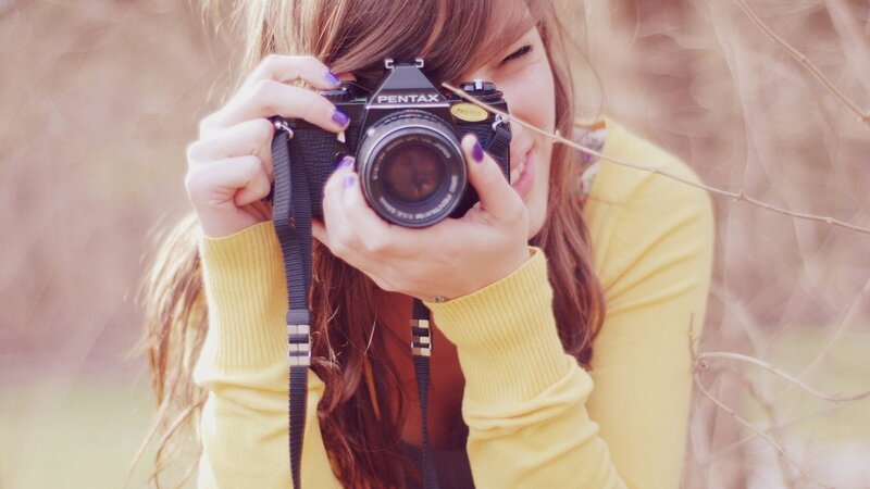 woman taking photo with camera