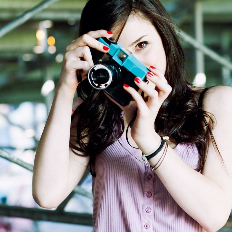 woman taking photo with vintage camera