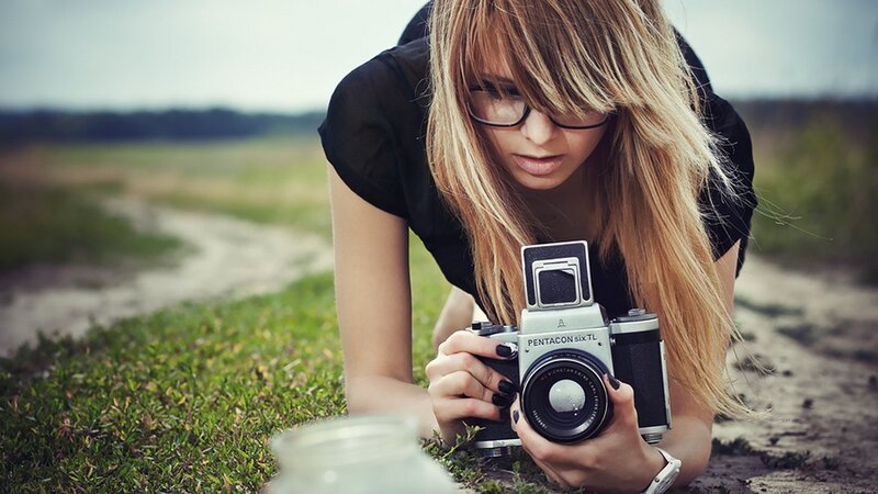woman taking photo with vintage camera