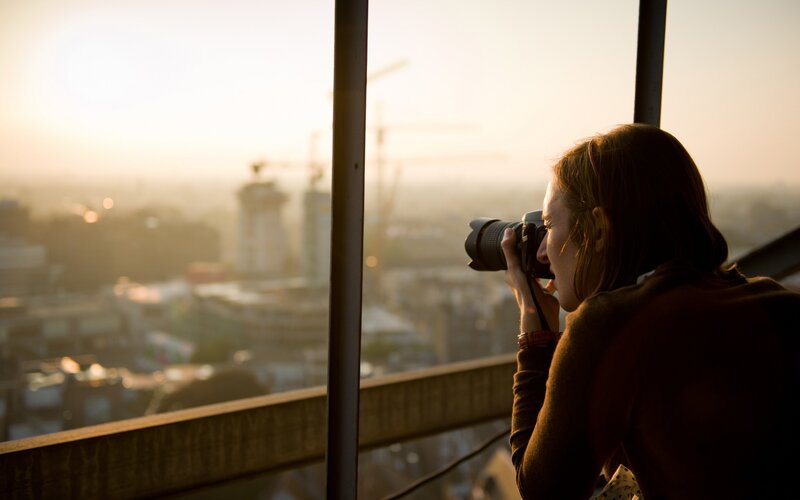 Woman Taking Photograph — Brown
