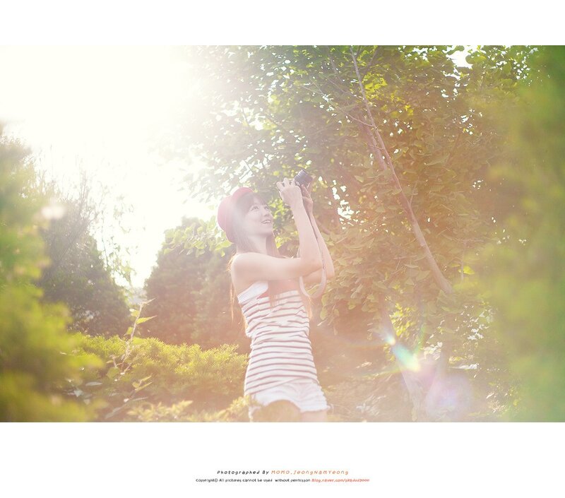Woman taking photos in sunlight